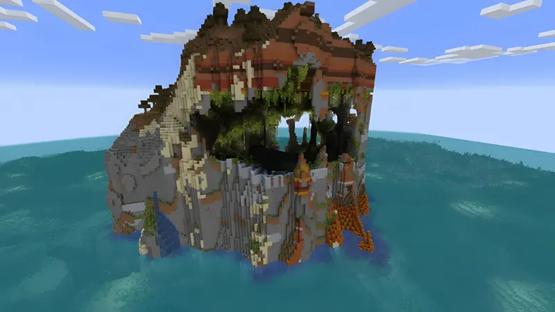 Tall hollow island with exposed lush cave